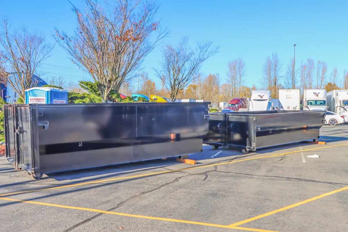 Professional dumpster rental service with roll-off container on residential driveway in Sand Lake